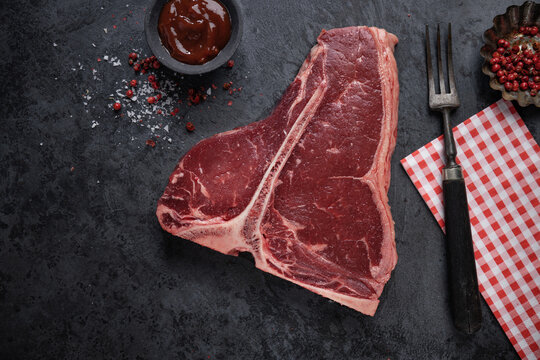 Fresh raw meat steak on dark blue background