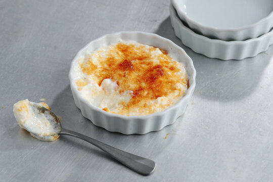 Creme brulee with spoon in bowl