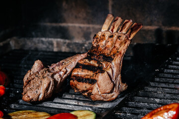 Meat lamb on the grill. Lamb ribs on board with grilled vegetables. Restaurant menu, Culinary,...