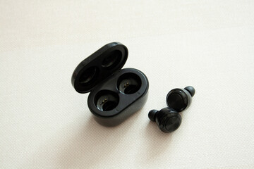 Obraz na płótnie Canvas wireless headphones black on white, couple duality