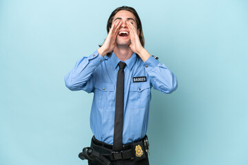 Young police caucasian man isolated on blue background shouting and announcing something