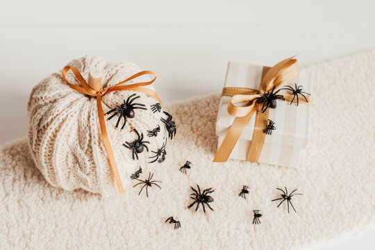 Modern interior decoration for halloween celebration with handmade knit pumpkin, spiders, bats and gift box