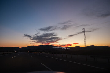 Fototapeta na wymiar On the Road before Sunrise with cloudscape