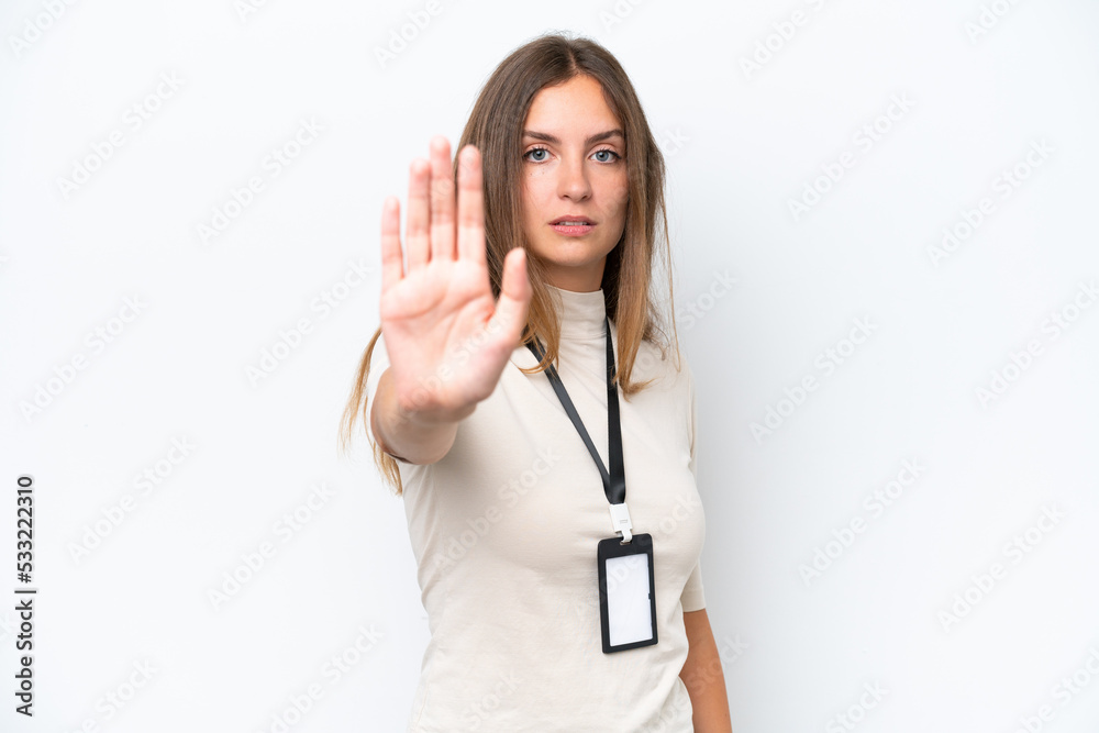 Wall mural young pretty woman with id card isolated on white background making stop gesture