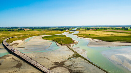 Stunning aerial view of the road and the colourful sand flats surrounding Le Mont Saint Michel...