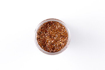 Flax seeds in a jar. Isolate on white background. Top view. Place for text