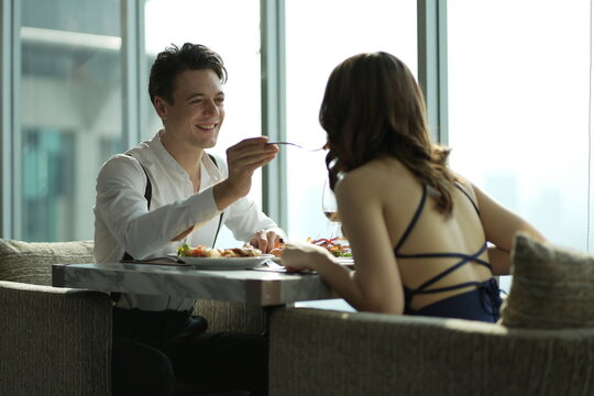 Couple dating and flirting in a restaurant. couple dating , propose marriage. Romantic couple on a date sitting in a restaurant.