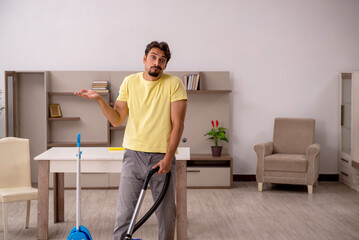 Young man doing housework at home