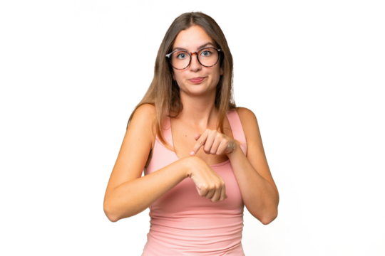 Young pretty woman over isolated background making the gesture of being late