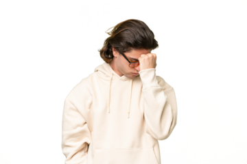 Young caucasian man isolated on green chroma background with headache