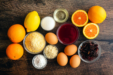 Upside Down Blood Orange, Hibiscus and Polenta Cake Ingredients: Ingredients for a dairy-free and gluten-free dessert on a wood background