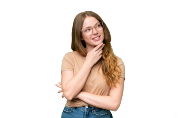 Young pretty woman over isolated background looking up while smiling