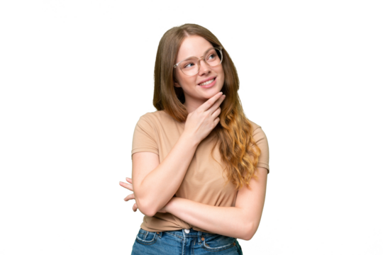 Young pretty woman over isolated background looking up while smiling