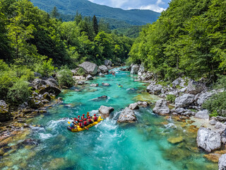 Soca Valley, Slovenia - Aerial view of the emerald alpine river Soca with rafting boats going down...