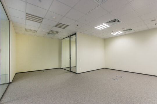 Office space in bright colors with a glass door, unfurnished.
