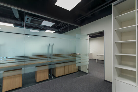 Spacious bright office space with glass door and partitions, ready to work.