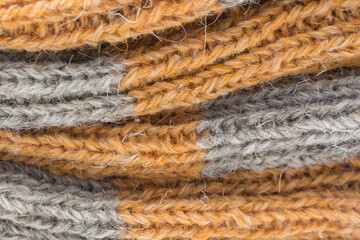 Detail of a rustic handmade product. Knitted wool background.