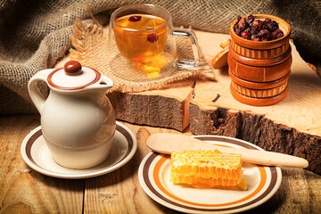 cup of herbal tea and ingredients on wooden table