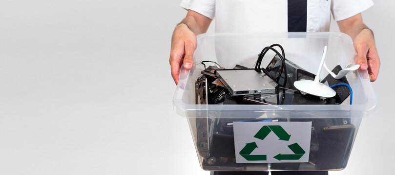 Hazardous E-Waste Recycling. Household electrical and scrapped electronic devices in recycle box. Sorting, disposing and recycling. Waste Electrical and Electronic Equipment. banner with copy space