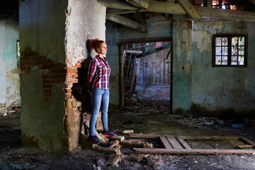 Fototapeta na wymiar Woman in a ruined house