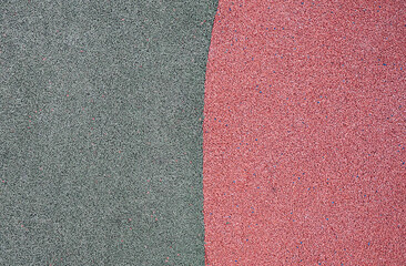 Fototapeta premium green and red pebbles texture background. park or playground flooring material. complementary colors