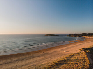 Fototapeta na wymiar Panoramic view of the coast at sunset during a surf and travel week experience in Somo, Cantabria (Spain)
