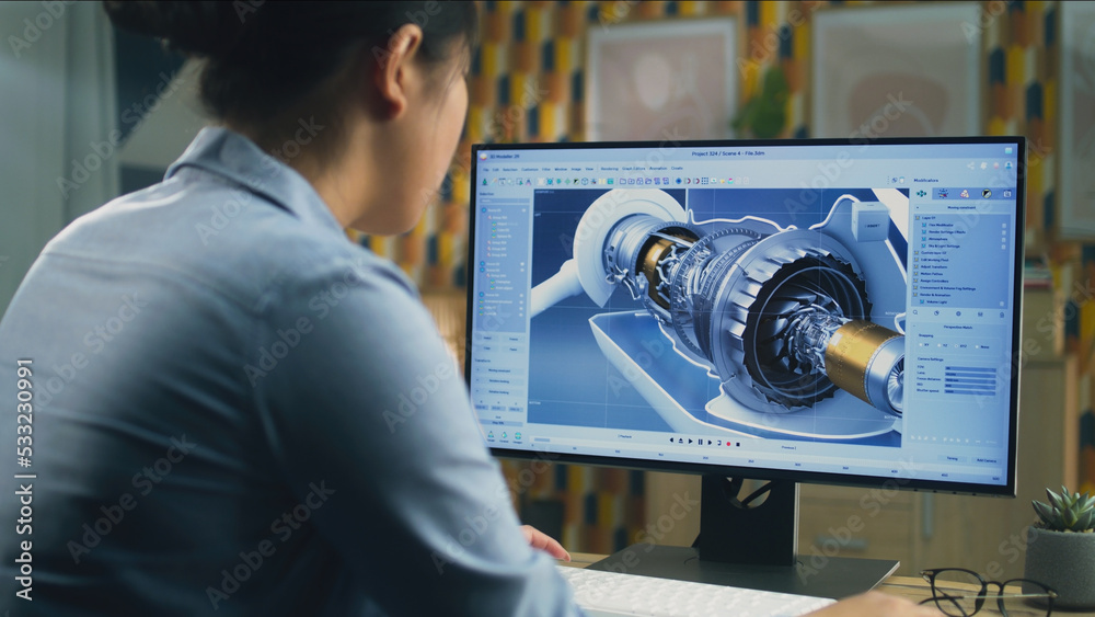 Wall mural asian female engineer drawing wind turbine 3d spare part in professional 3d modeling program on pc w