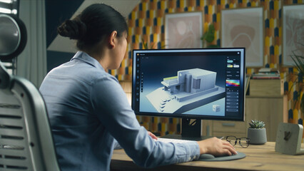 Female 3D designer at home working on 3D modeling project of house and creating exterior in...