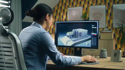 Female 3D designer at home working on 3D modeling project of house and creating exterior in...