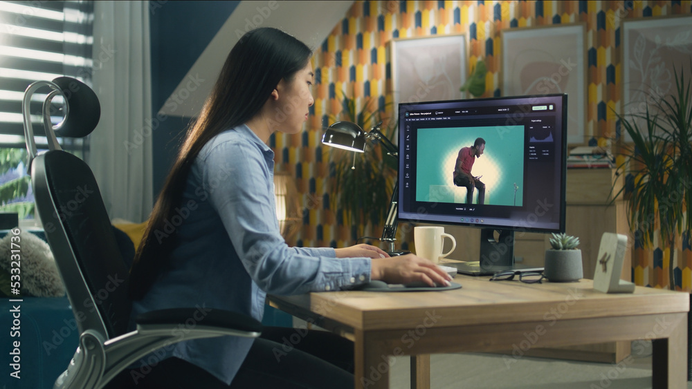 Canvas Prints asian woman editing photo in photoshop for customer on personal computer while sitting at the table 