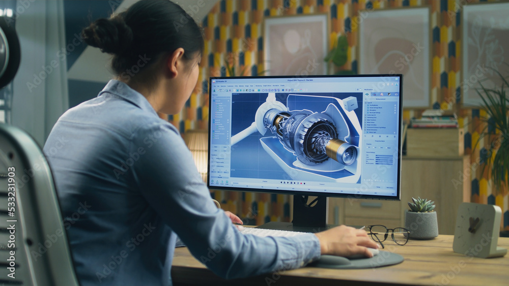 Wall mural asian female engineer drawing wind turbine 3d spare part in professional 3d modeling program on pc w