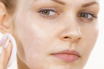Fototapeta premium Girl removes mask cosmetic
