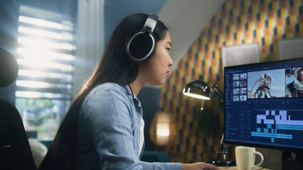Asian woman in headset editing video with astronauts for client in program on personal computer...