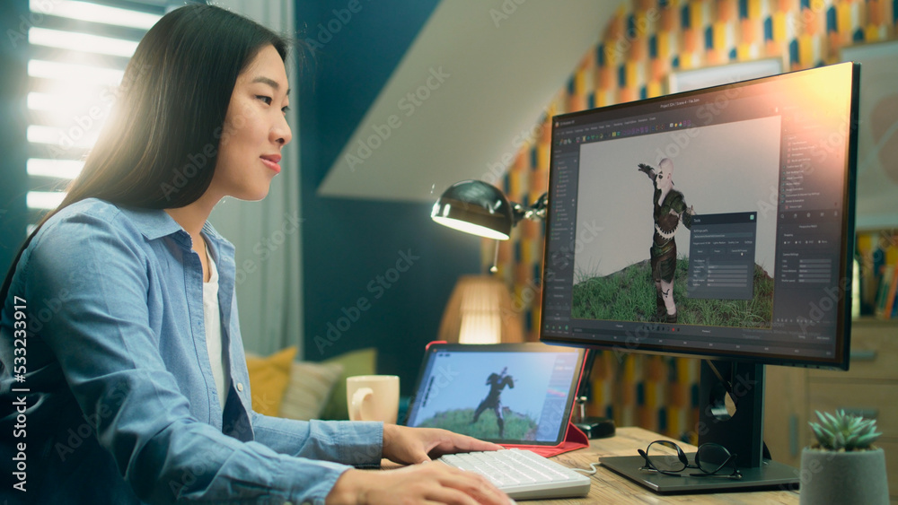 Poster Asian female 3D designer creating visualization and animation for video game character while working on 3D project using pc and digital tablet computer