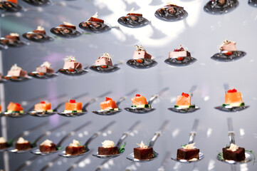 many different small canapes on spoons