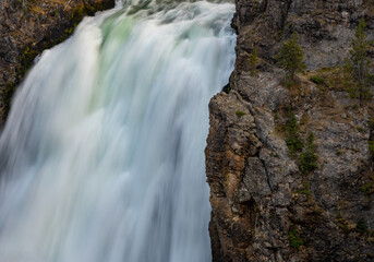 Obraz premium Solid Rock And Flowing Water Compete For Space At The Upper Falls Of The Yellowstone River