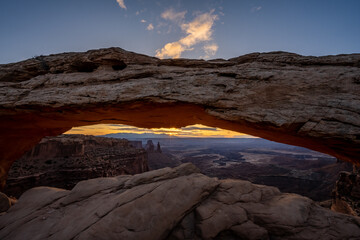 Sun Starts to Break The Horizon Framed By Mesa Arch