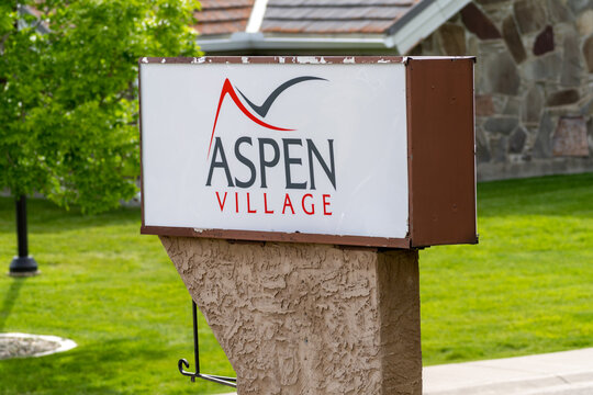 Waterton, Alberta, Canada - July 5, 2022: Sign for Aspen Village, a hotel and motel complex for tourists to stay in town