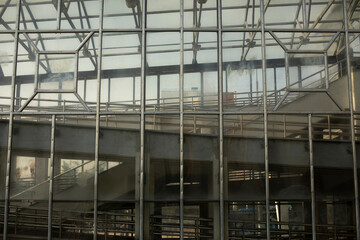Glass pedestrian crossing building. Bridge over road. Interchange. Details of technical structure.