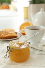 Breakfast with delicious orange marmalade on table. Space for text
