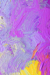 Closeup view of artist's palette with mixed paints as background