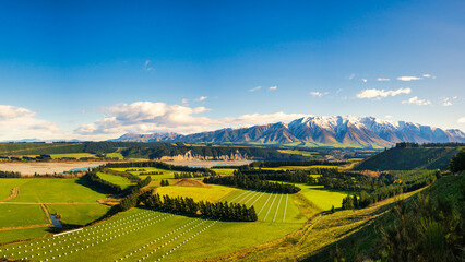 Near the village of  Windwhistle looking over agricultural farming fields and the Rakaia Gorge towards Mt Hutt with a slight dusting of snow on the mountain peak