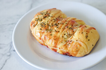 Sausage buns bread. Soft baked bun (dough) stuffed with sausage for fast food breakfast or coffee break. Sausage roll, (hot dog). With mayo, tomato sauce, mozarella cheese and parsley topping