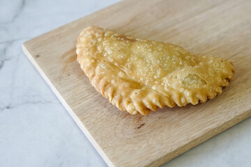 Cornish pasty filled with chicken and potato. Pastry minced pie or Pastel asian style cuisine. Homemade flaky pasty with mince meat filling	
 - obrazy, fototapety, plakaty