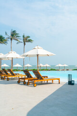 umbrella with bed pool around swimming pool with ocean sea background