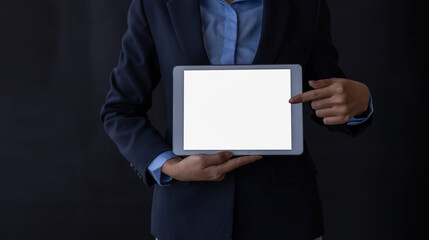 Close up of business woman standing and holding tablet blank white screen on black background