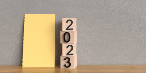 Wooden cube 2023 happy new year merry christmas notebook on table business goal planning vision...