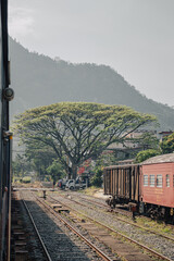 Train tracks at the railway station in Gampola, central Sri Lanka with a mountain in the background