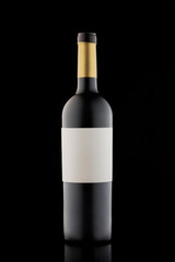 Bottle of red wine on a black background. Stylish alcohol