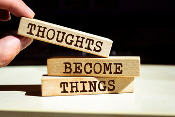 Wooden blocks with words 'Thoughts Become Things'.